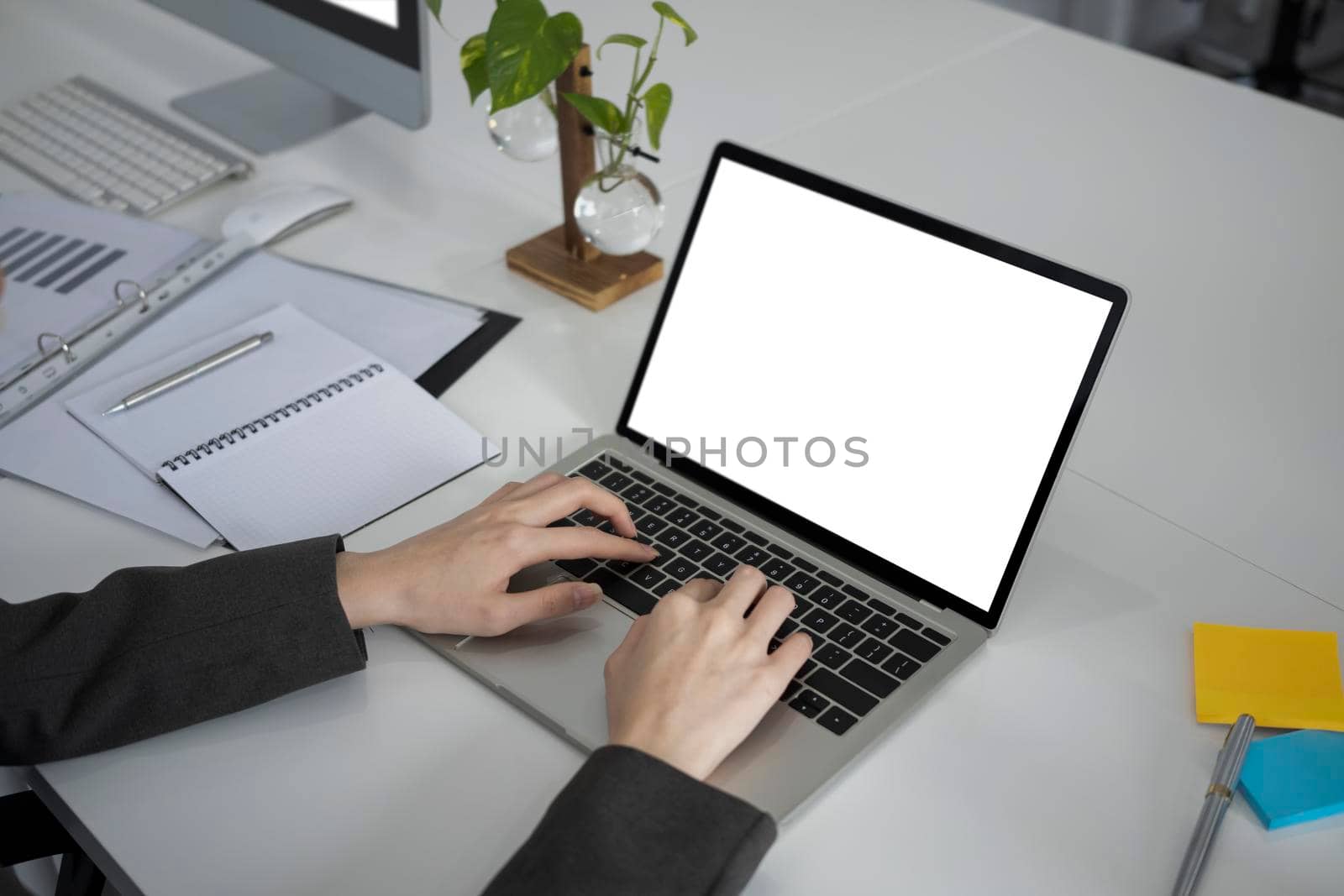 Close up view businesswoman working with computer laptop on white office desk.