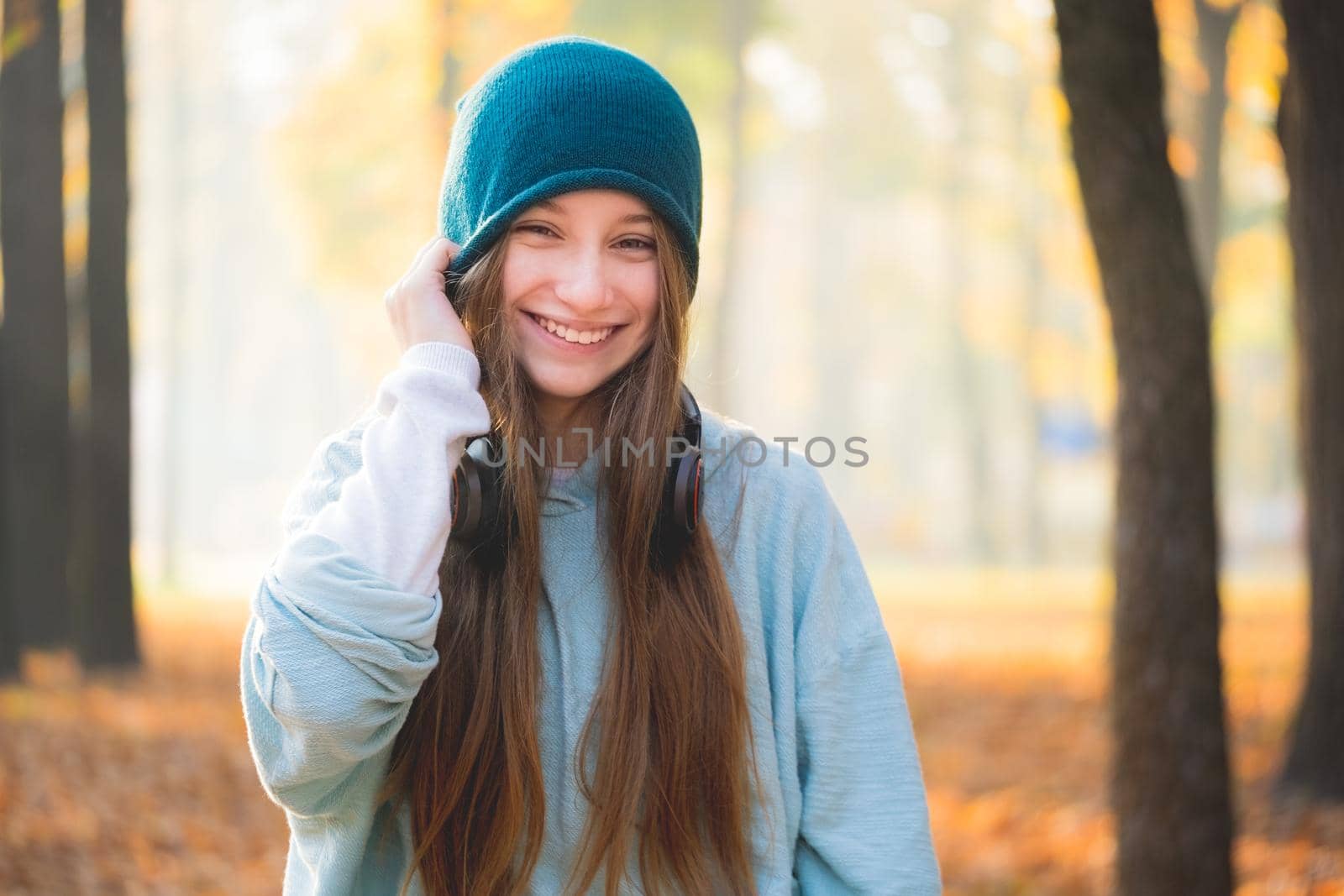 Smiling teenage girl in headphones outdoors