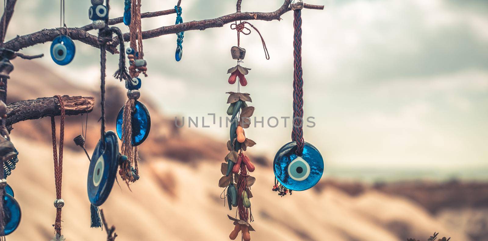 Amulets from evil eye hanging on tree by GekaSkr