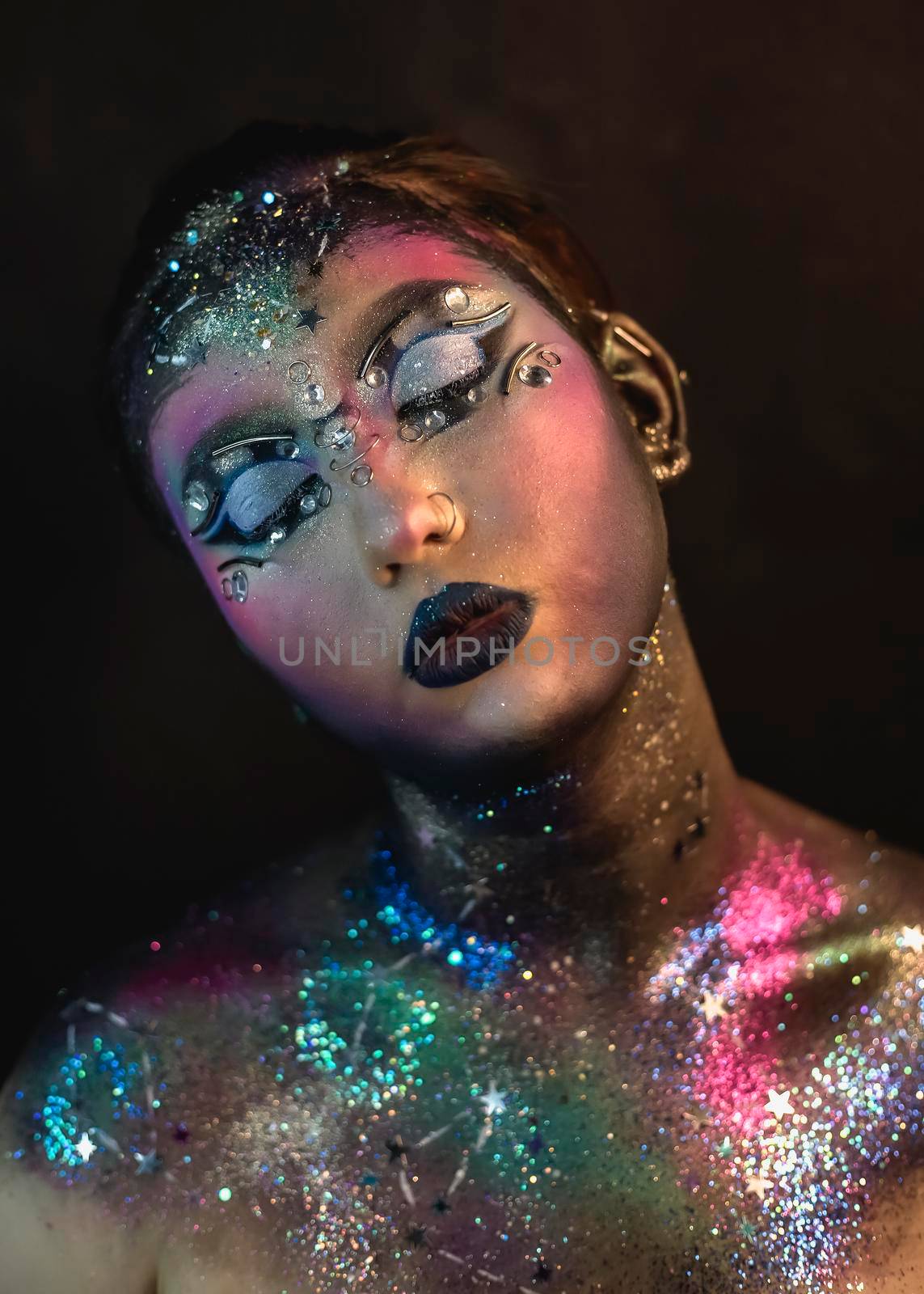 Creative make-up of a girl with rhinestones and piercing by Multipedia