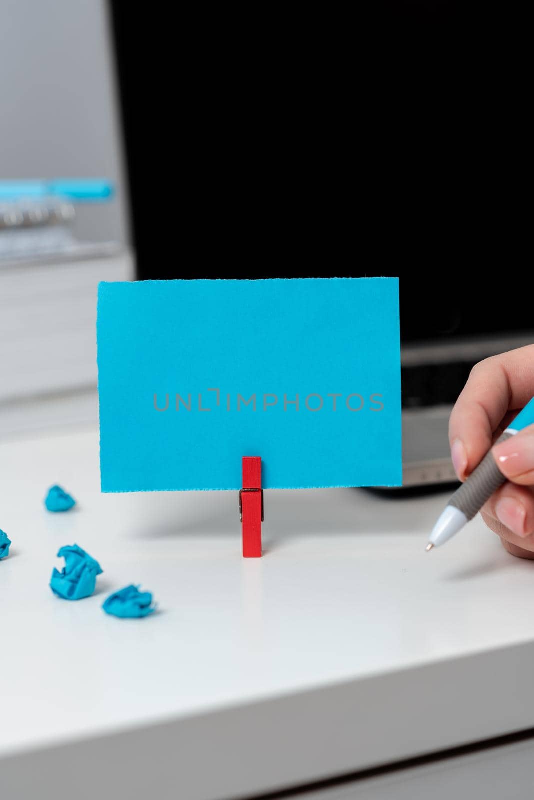 Businesswoman Holding Pen On Desk With Lap Top,Paperwraps And Note With Important Data. Woman Having Pencil In One Hand On Table With Computer, Notebooks And Memo With Ideas. by nialowwa