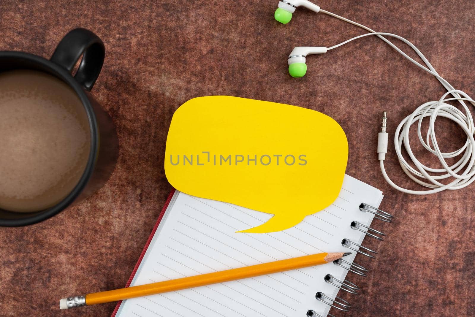 Blank Paper In Thought Bubble Shape With Spiral Book, Pencil, Coffee Mug And Headphones Wood. Note With Listening And Writing Device Representing Expression Of Opinions. by nialowwa