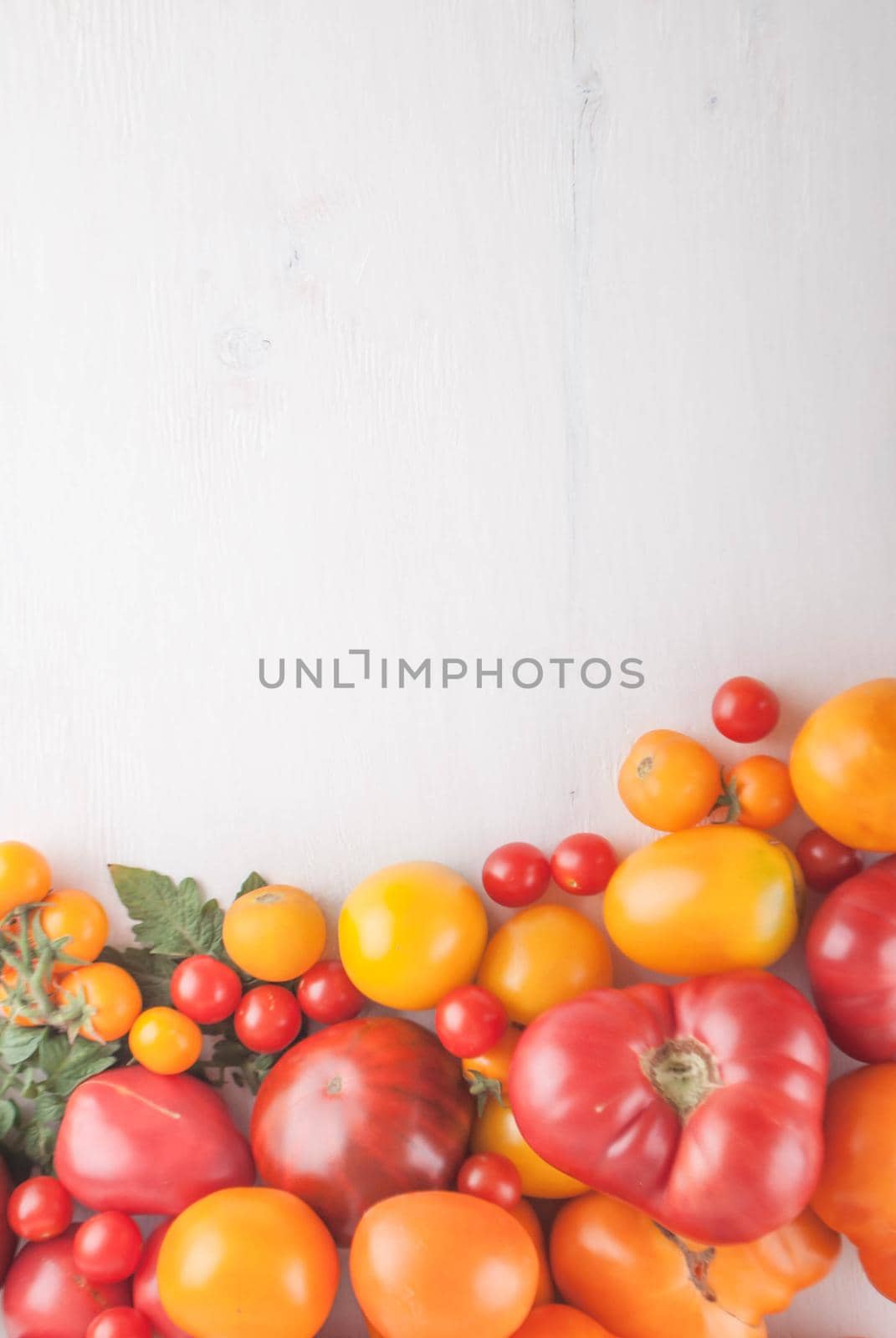 variation of fresh ripe tomatoes on wooden background