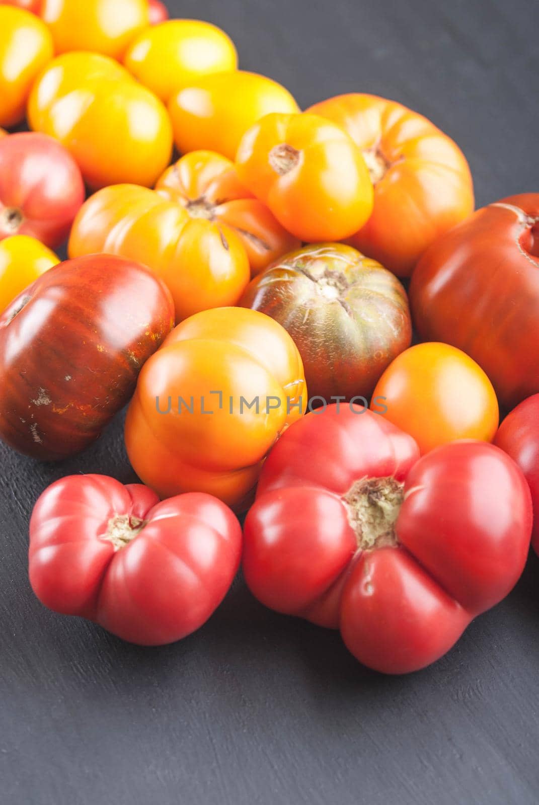 variation of fresh ripe tomatoes on wooden background
