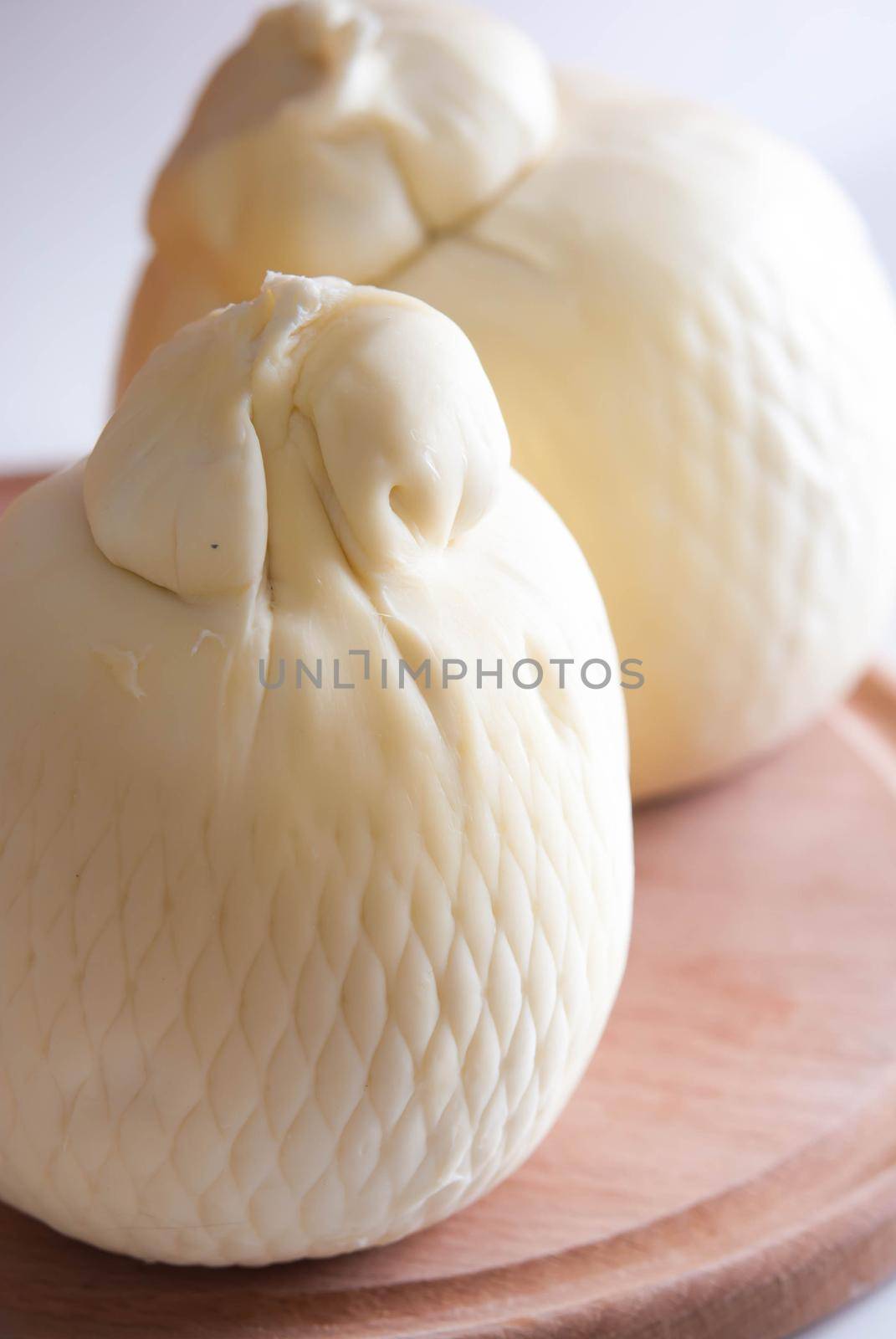 fresh italian cheesse caciocavallo on wooden board