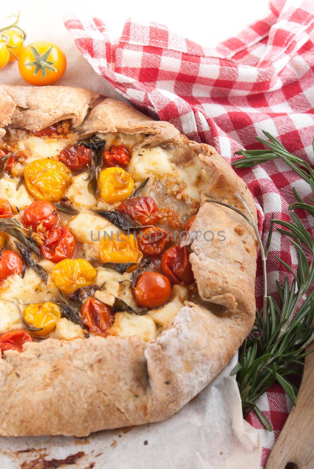 delicious pie with cherry tomatoes, feta cheese herbs by maramorosz