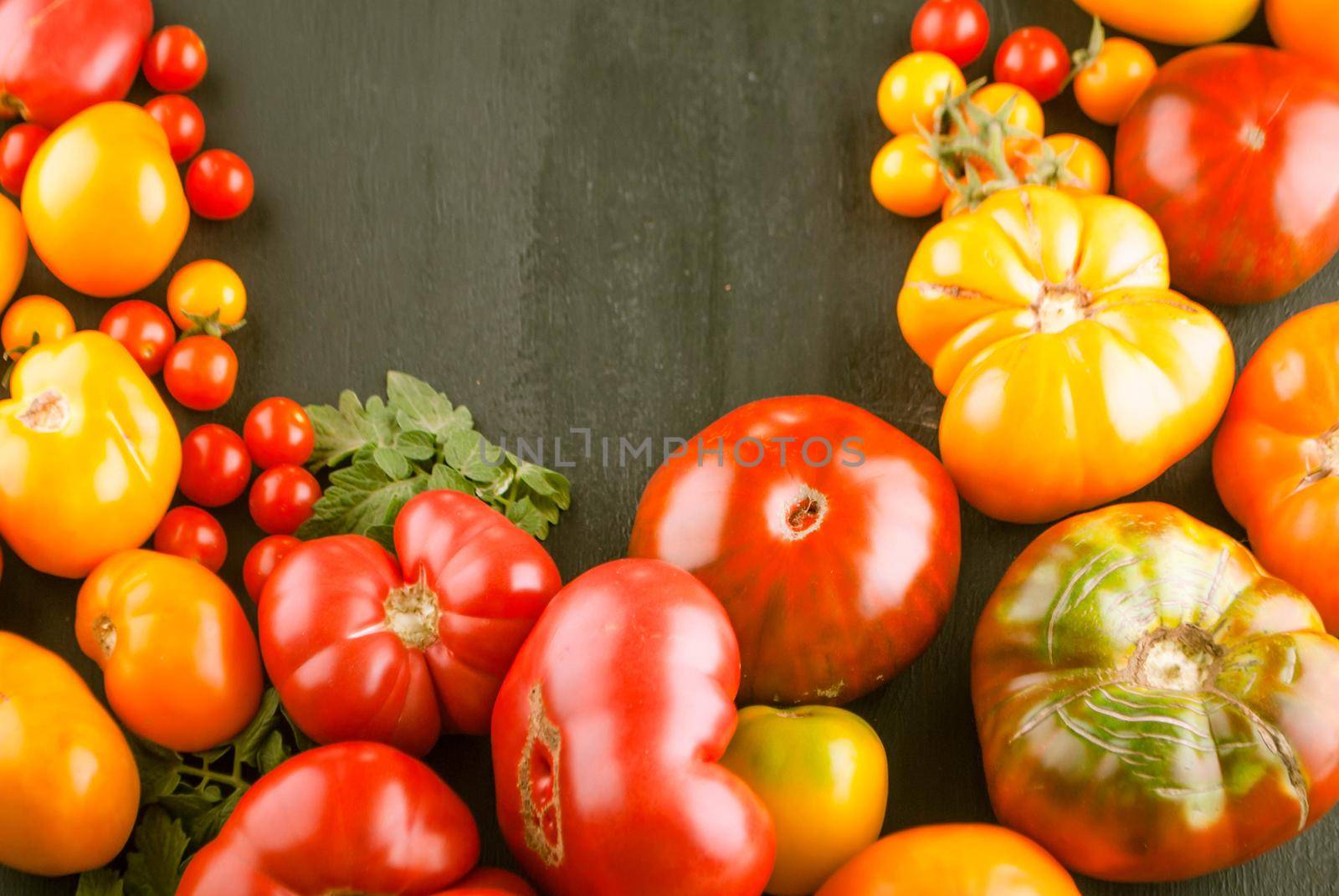 variation of fresh ripe tomatoes on wooden background