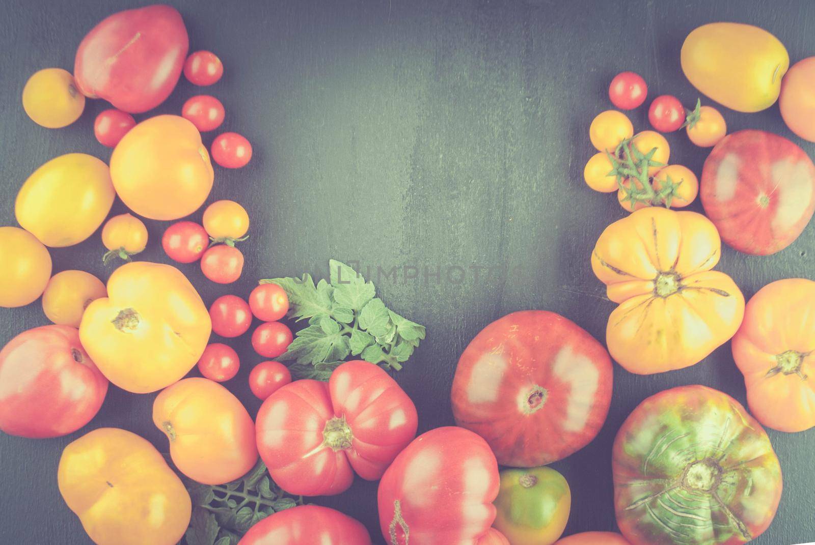 variation of fresh ripe tomatoes on wooden background