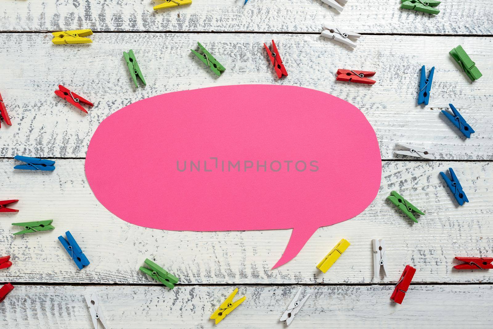 Colorful Pegs Placed Around Speech Bubble With Important Information.