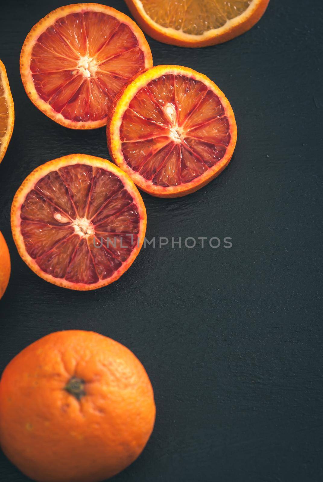 red bloody sicilian oranges on black background