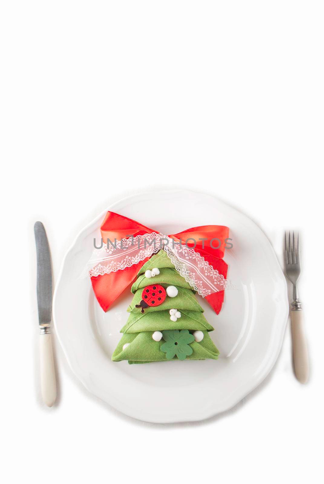 table set with napkin made in form of New Year isolated in white background