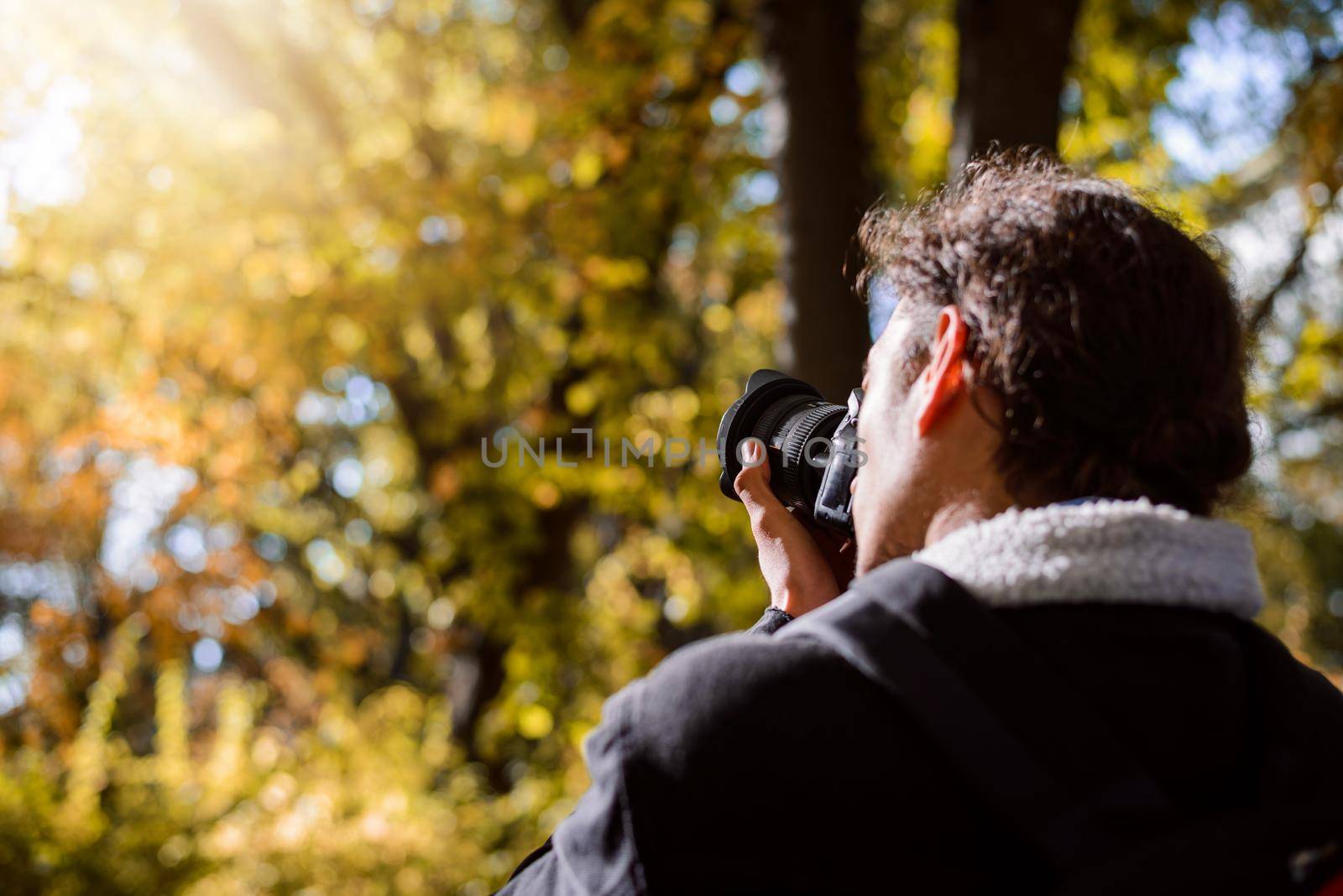 Photographer taking pictures in forest by VitaliiPetrushenko
