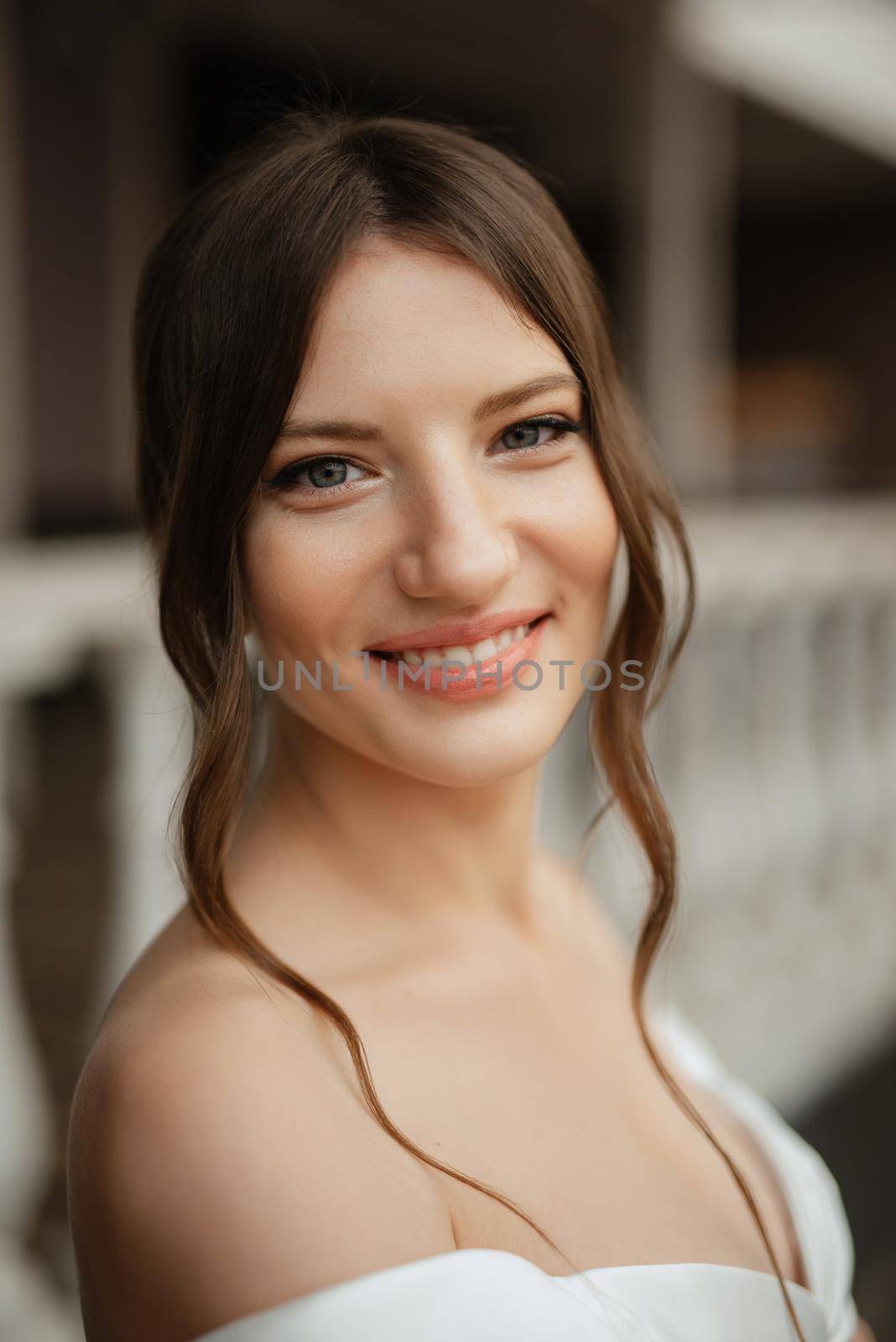 portrait of a young bride girl in a short white dress on a rainy day