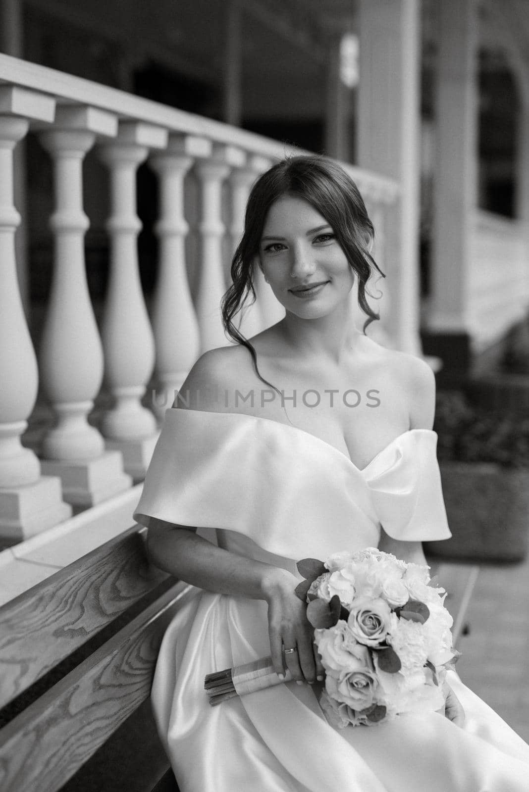 portrait of a young bride girl in a short white dress on a rainy day