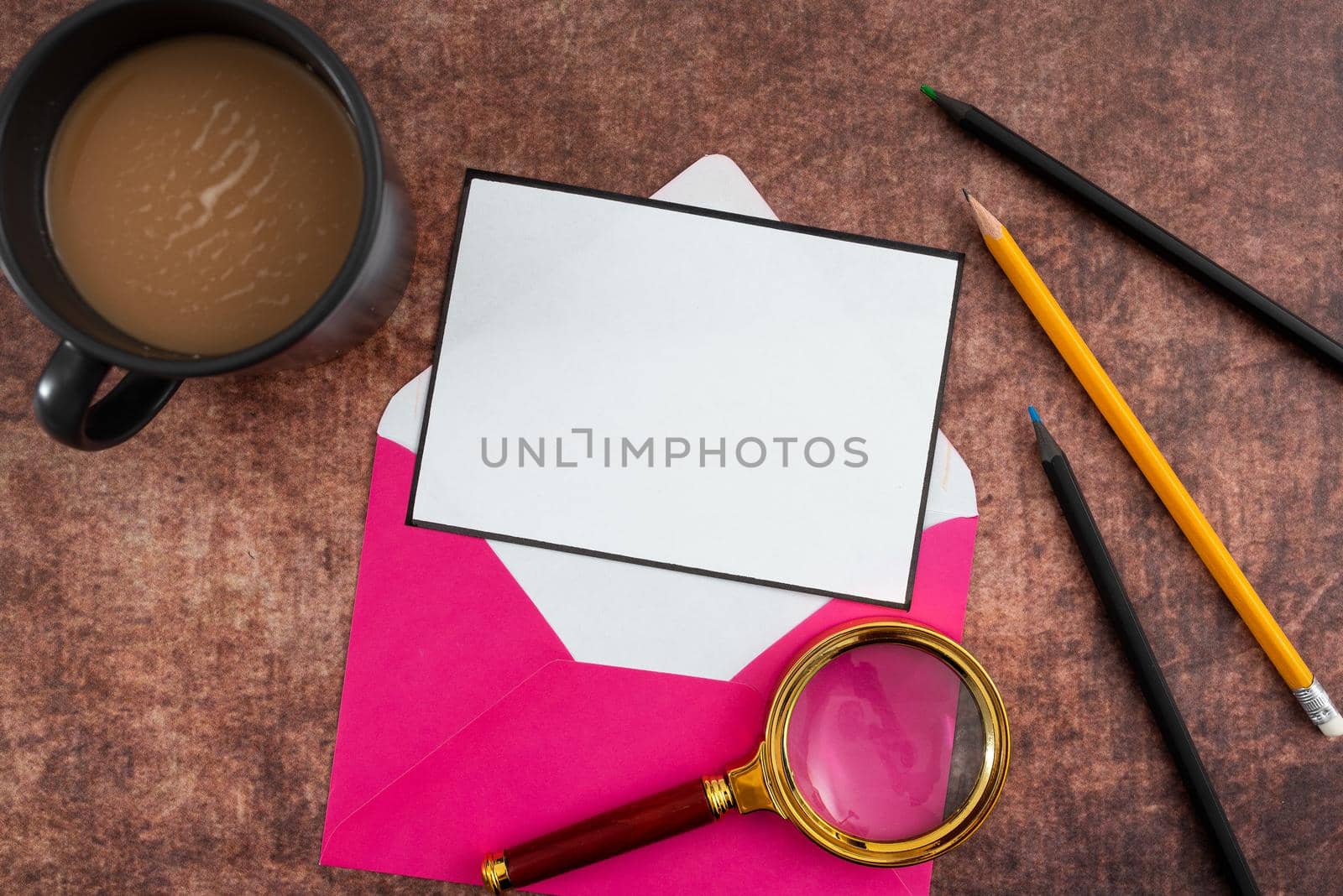 Blank Paper In Thought Bubble Shape With Envelope, Pencils, Coffee Mug And Magnifying Glass On Table. It Is Representing New Strategies For Achieving Business Goals. by nialowwa