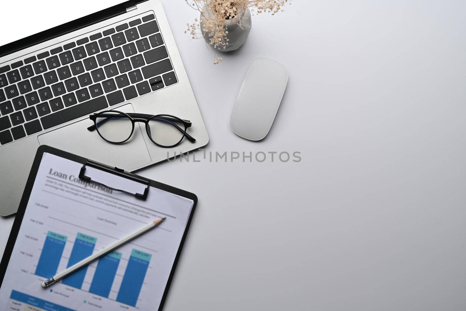 Above view white office desk with notepad, financial document and calculator.