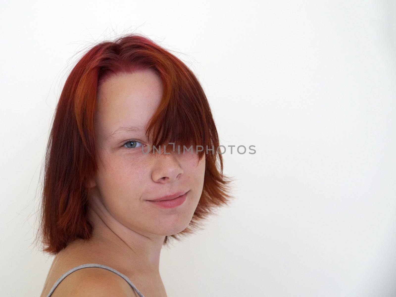 Portrait of smiling teenage girl on white background copy space by Annado