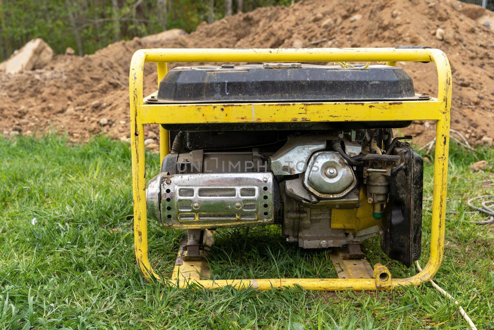 portable gasoline generator operating on a construction site.