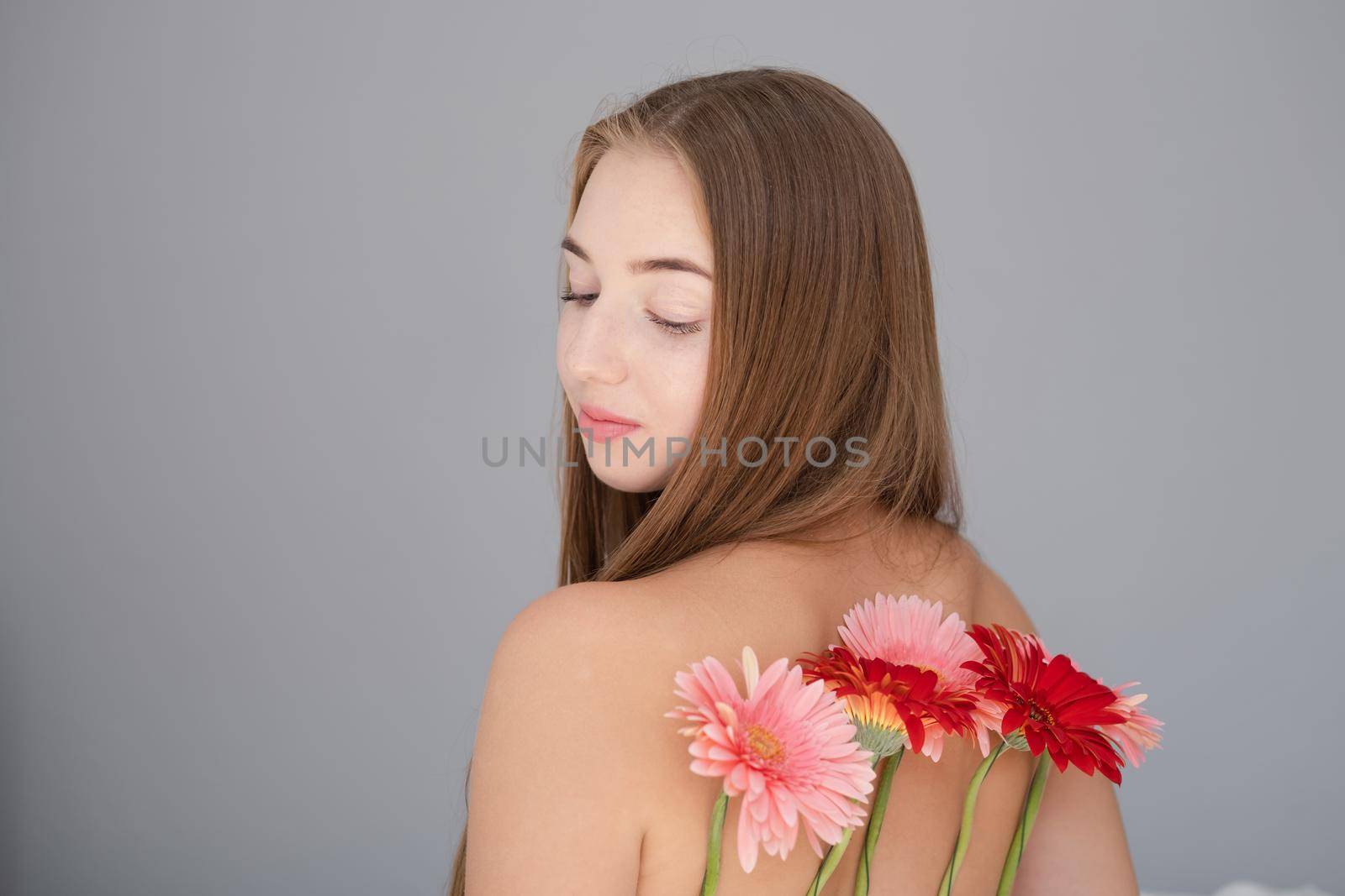 Portrait of pretty young woman with pink and red chrysanthemum flowers by oliavesna