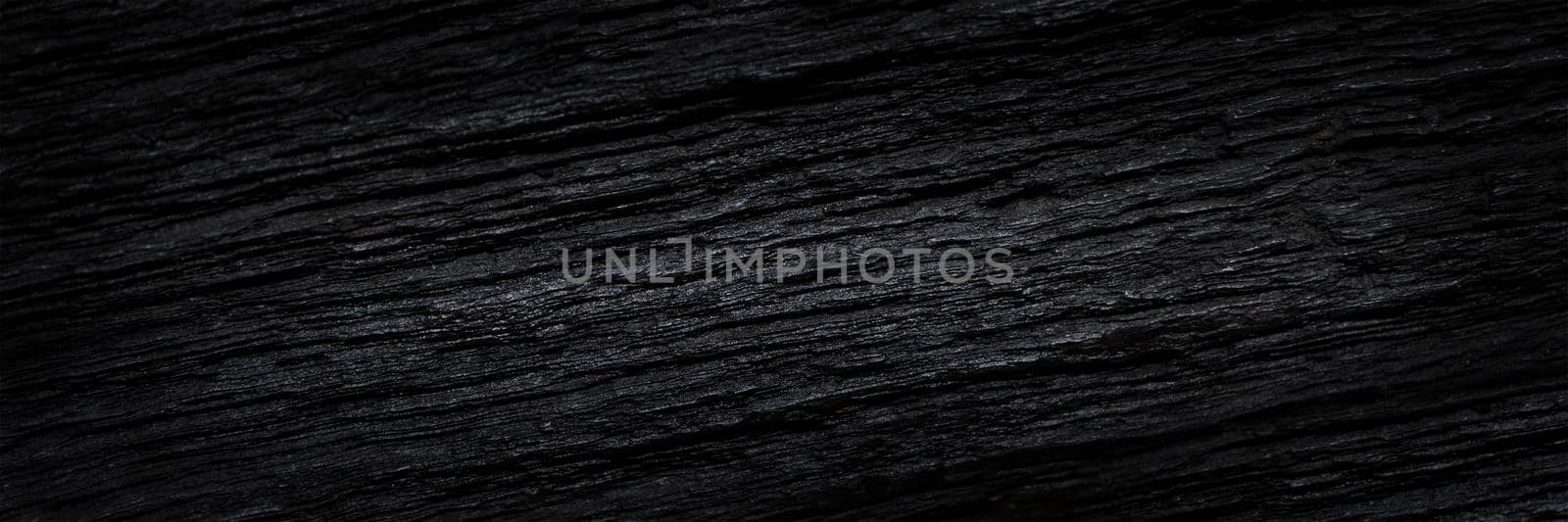 Texture of black old wood. Close-up of the texture of deep black bog oak. Sinuous wood texture with shadow. by SERSOL