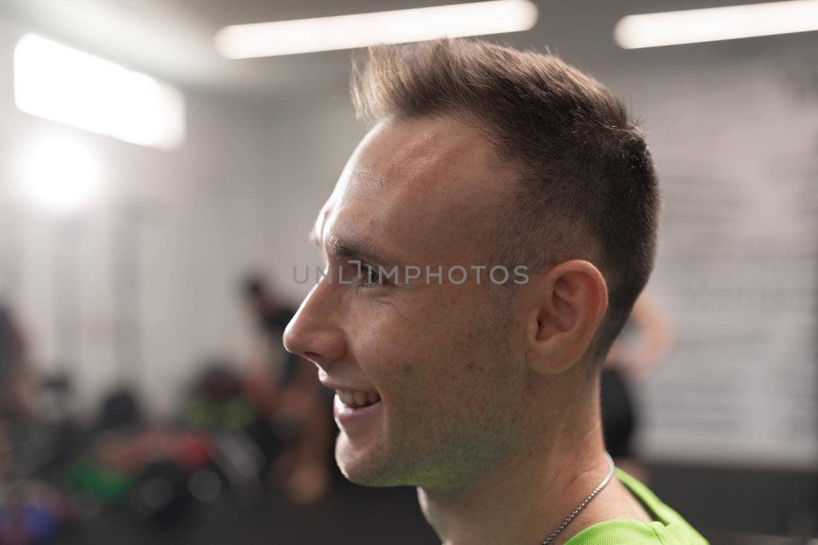 Portrait of a young man smiling during a training session at the local fitness center