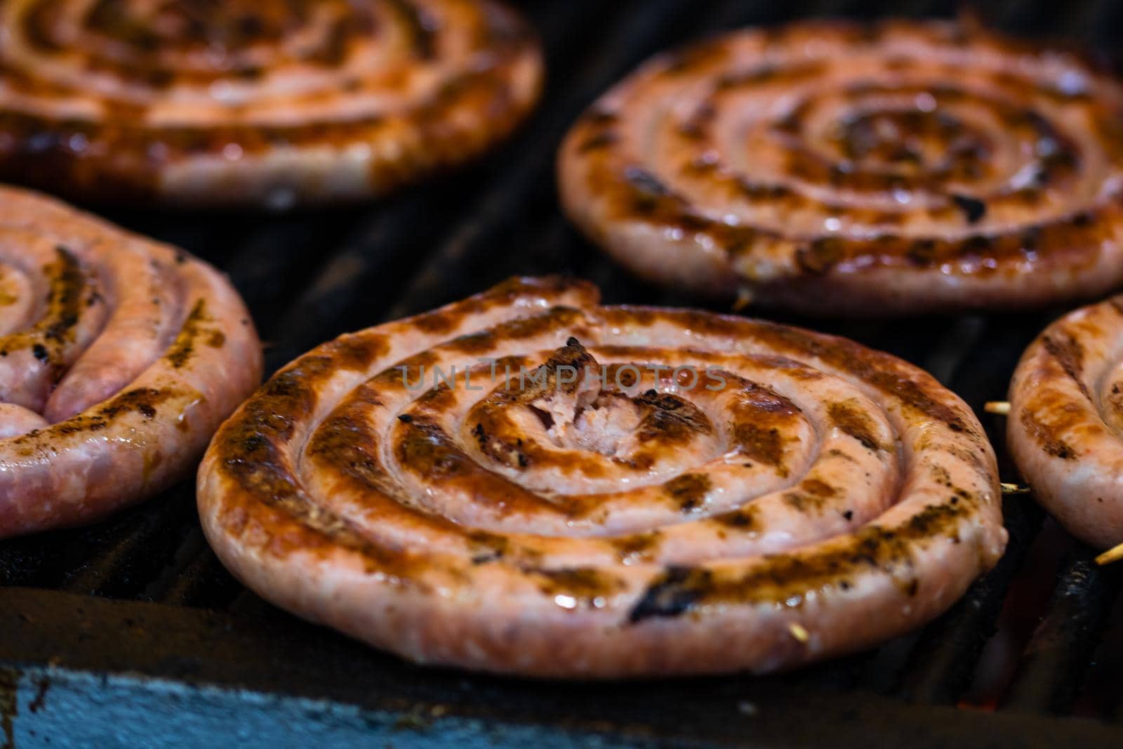 Grilling tasty food on barbecue. Steak, sausages on grill at food festival