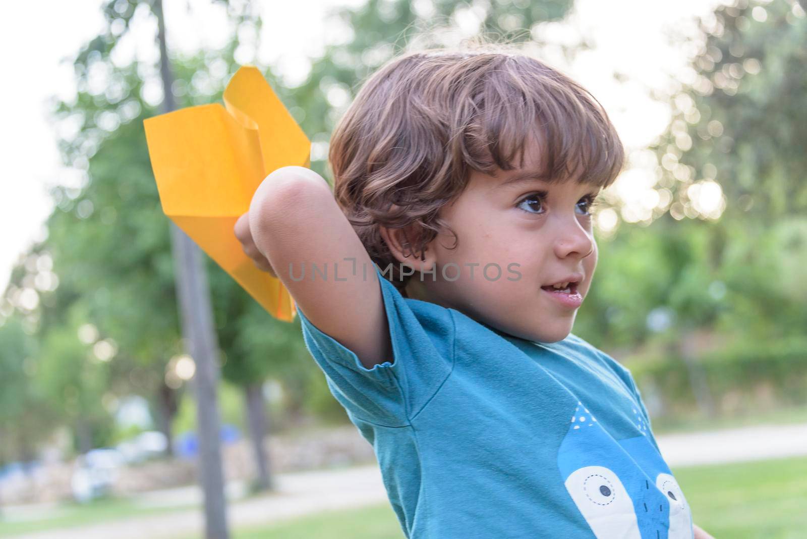 Happy kid playing with toy airplane against summer sky background at sunset. by jbruiz78