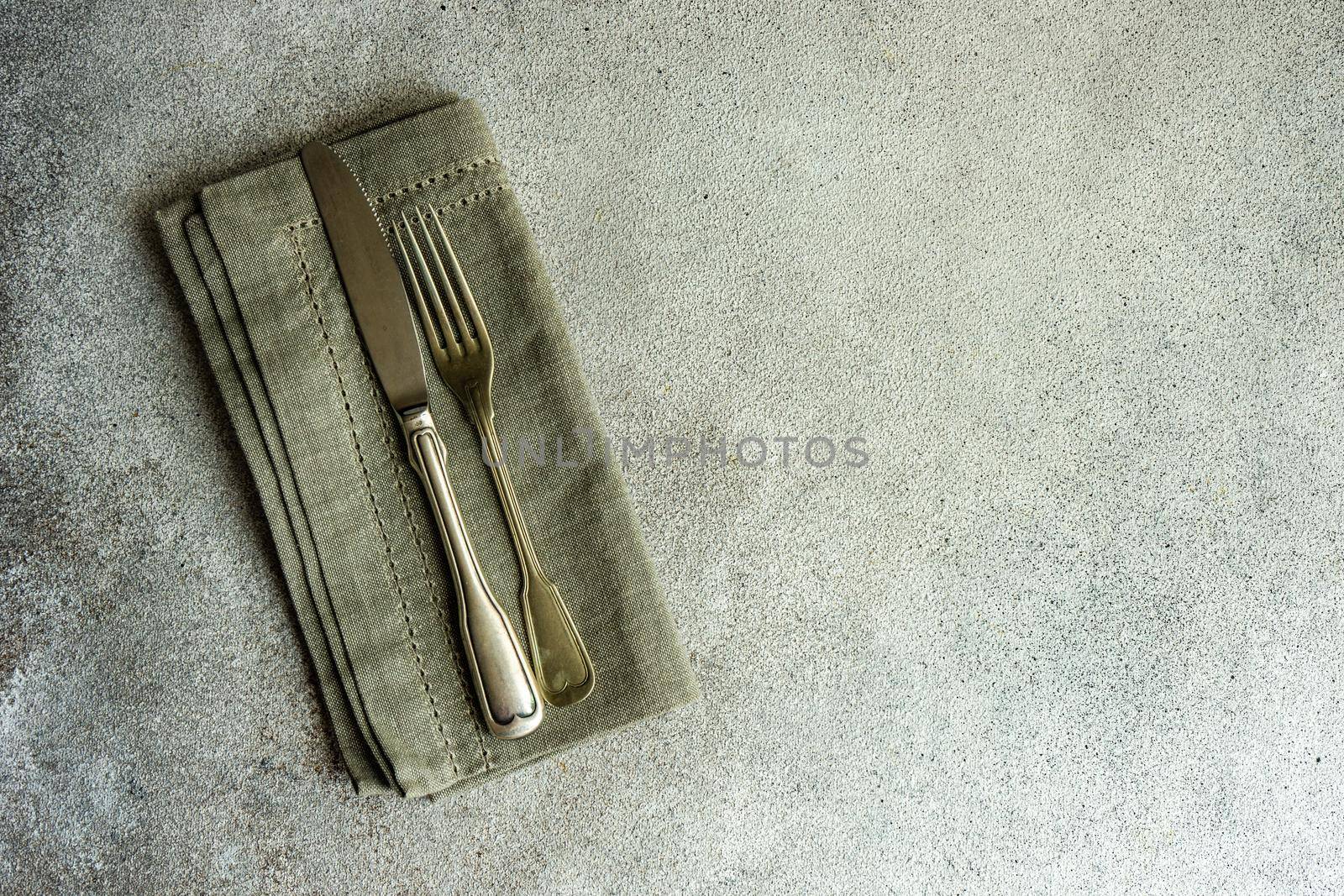 Overhead table setting in minimalistic style on concrete background