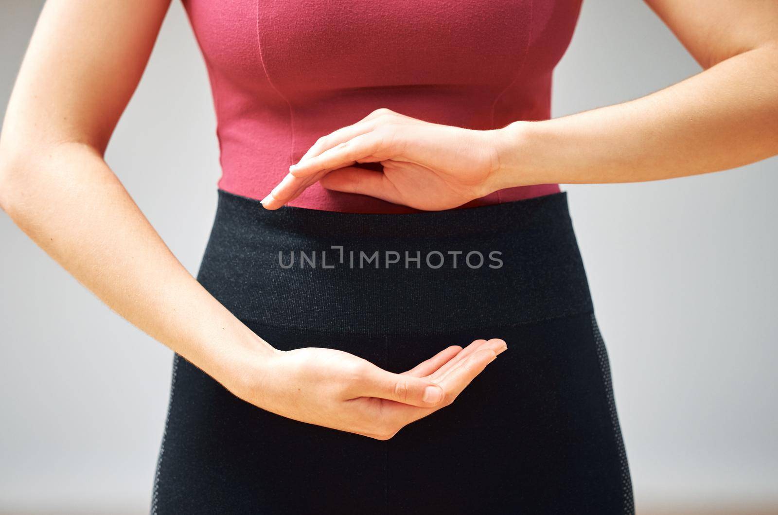 Ive never been more in tune with my body. a woman forming a circle with her hands in front of her belly