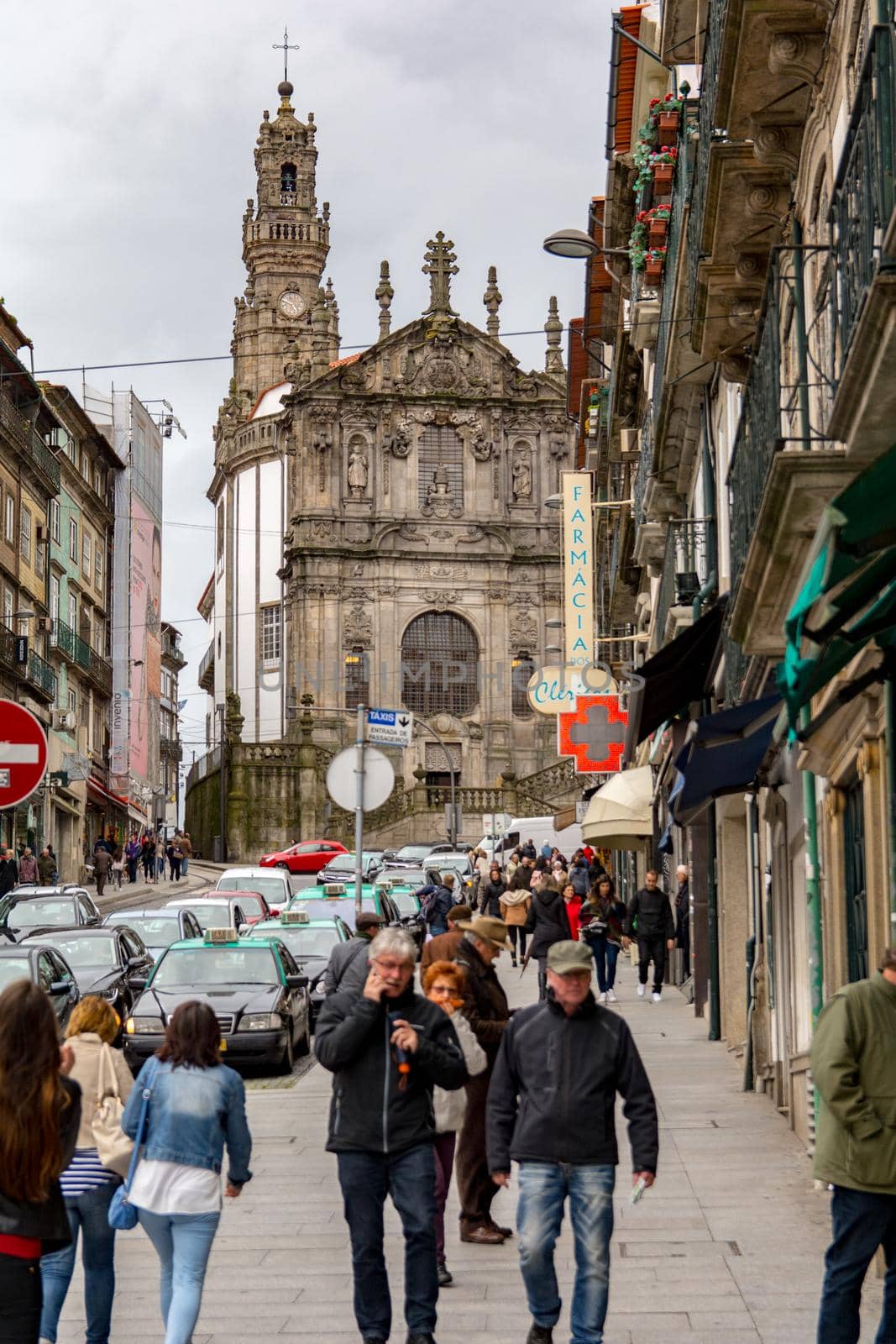 Porto,Portugal; 12/06/2016. People wlak for the street whit the Clerigos Tower in back. by martinscphoto