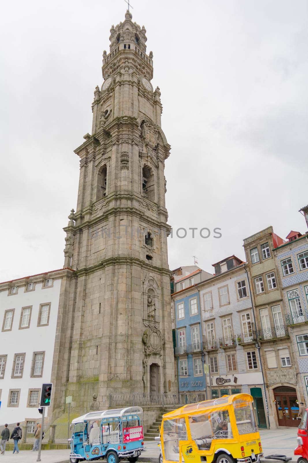 Porto,Portugal; 12/06/2016 : View of the beautiful baroque Church of Clerigos (Igreja dos Clerigos, in Portuguese) and iconic Clerigos Tower, one of the landmarks and symbols of Oporto city in Portugal. Sunset color in blue sky. by martinscphoto