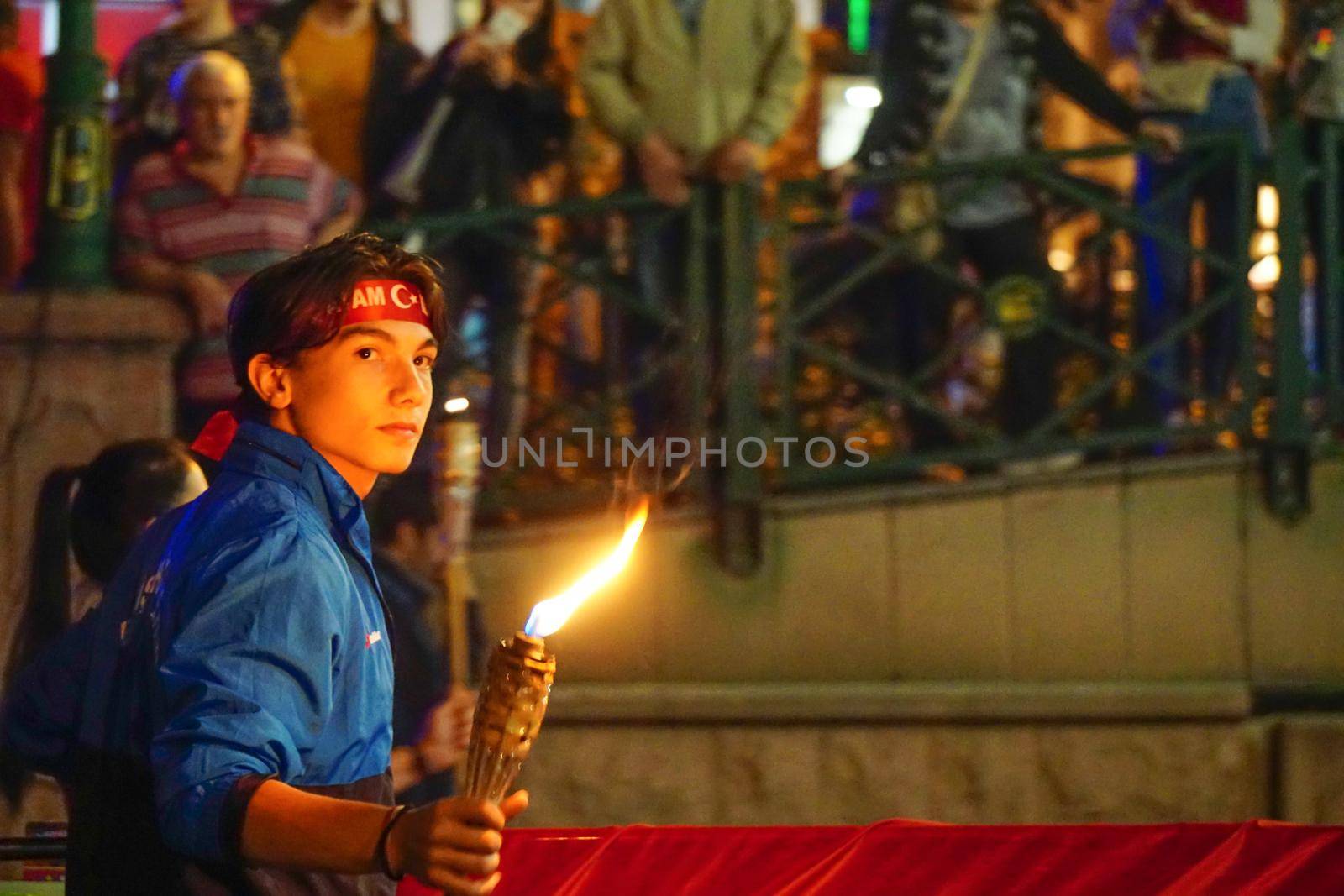 19 May 2019 Eskisehir Turkey. Young boy holding fire torch that symbolises the independence of Turkish nation on 19 May National Independence Parade