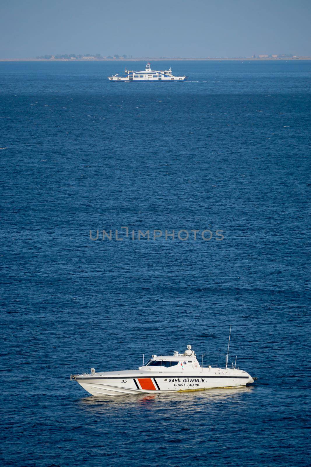 22 July 2021 Izmir Turkey. Coast guard boat and ferry in the same scene in the morning