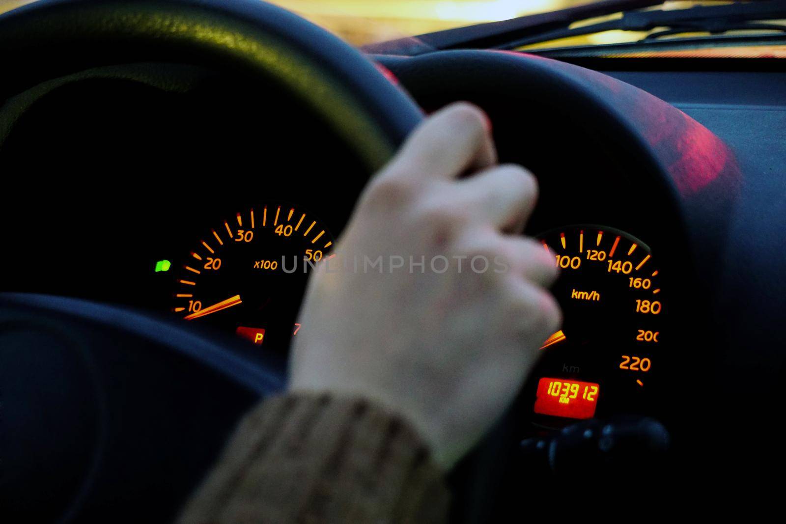 Car dashboard and drivers hand close up