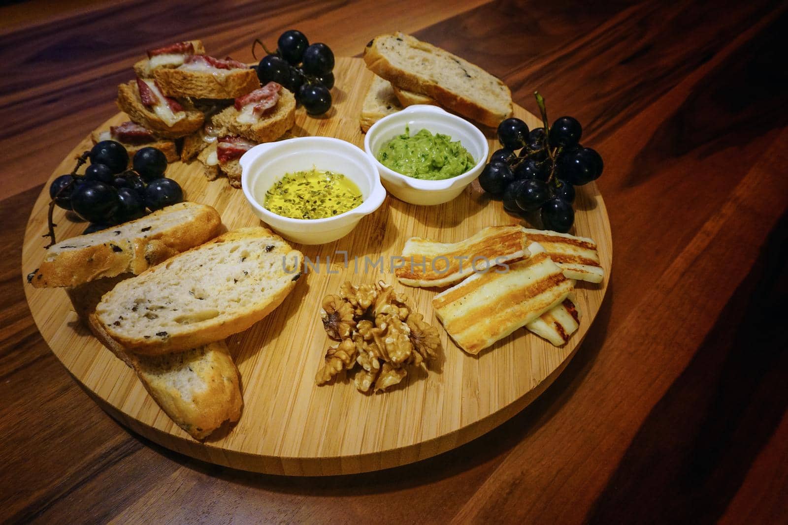 Red wine and appetizers on wooden background