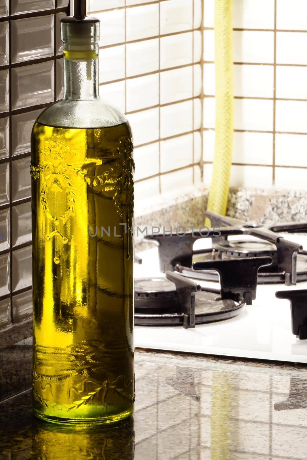 Olive oil bottle in the kitchen by tasci