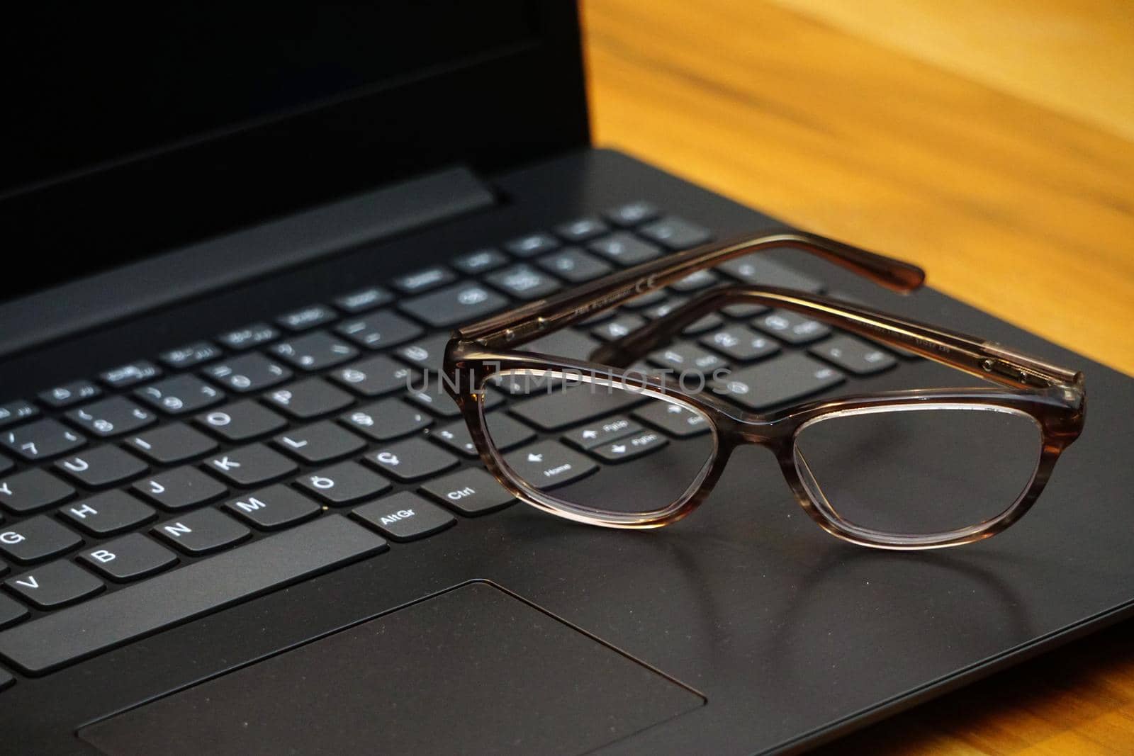 Glasses and computer keyboard close up view business concept on wooden background