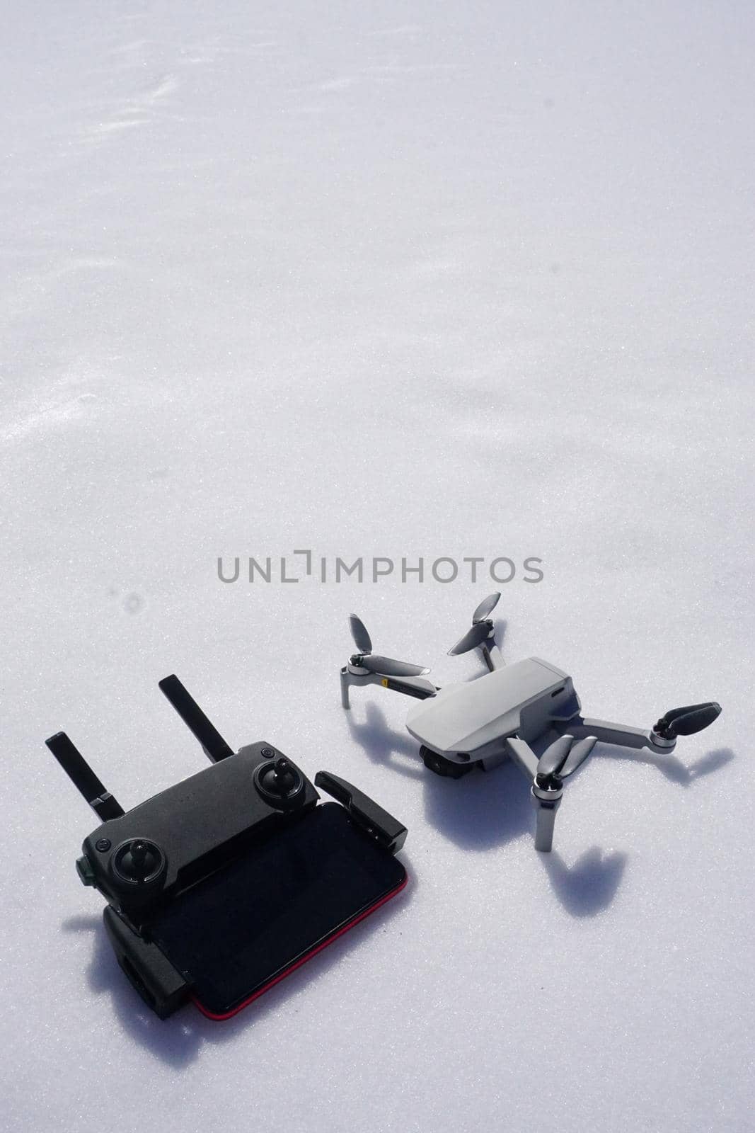 Drone and controller on snow close up view