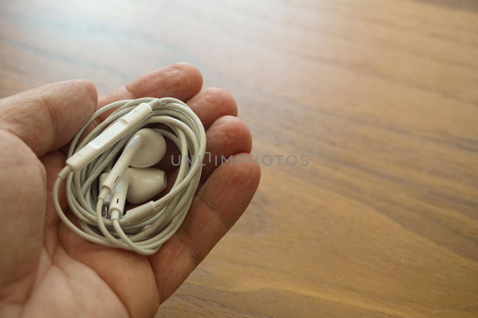 15 August 2021 Eskisehir Turkey. Apple cable headphones in man's hand close up view