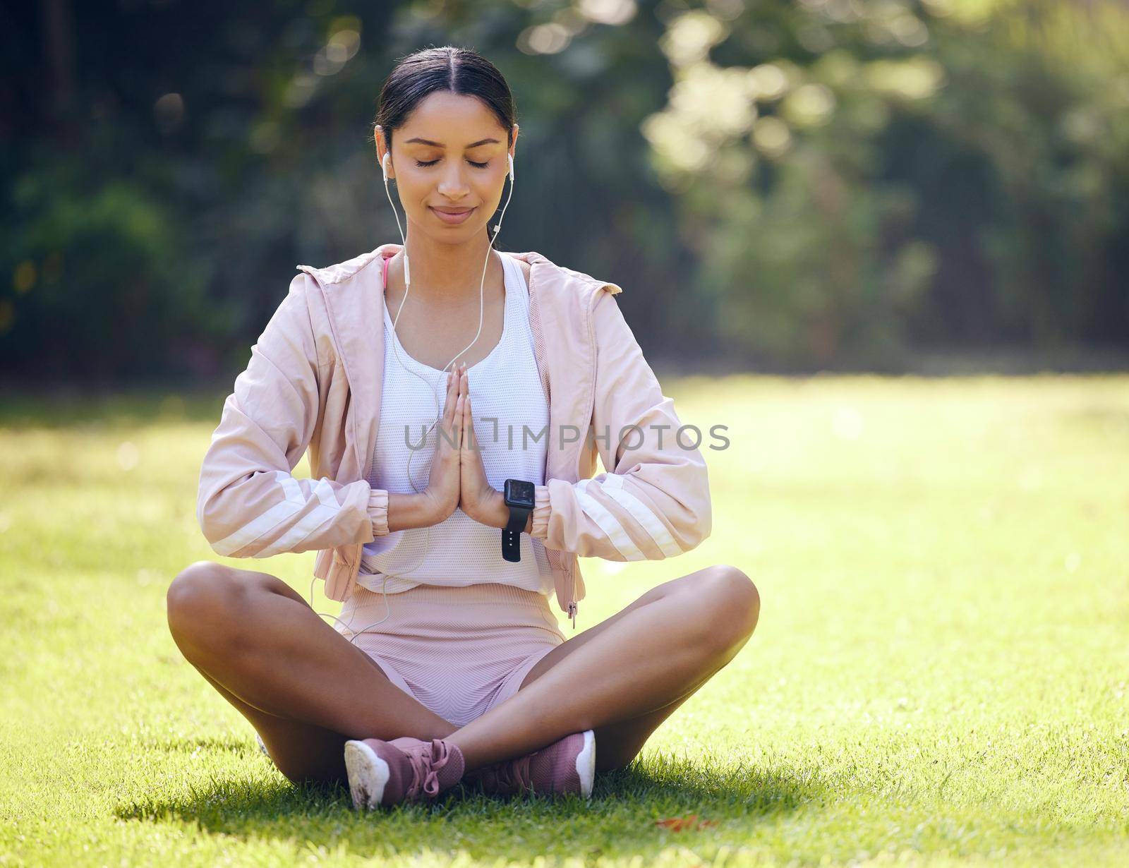Peace is attainable through focus. a sporty young woman meditating while exercising outdoors. by YuriArcurs