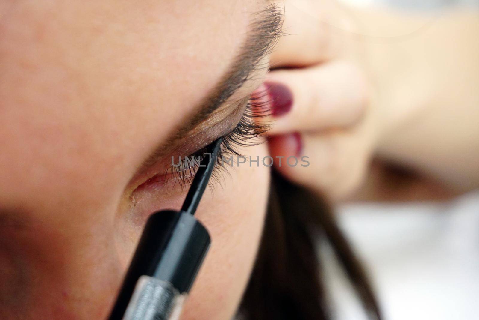 Woman making eye make up close up view