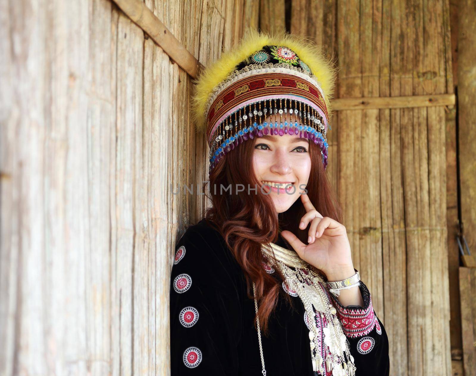 Traditionally dressed Mhong hill tribe woman in the wooden cottage