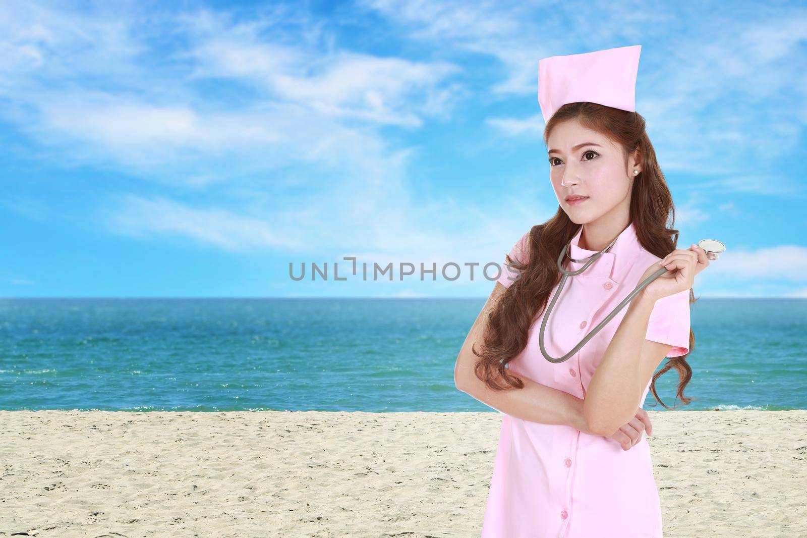 female nurse with stethoscope with sea beach background