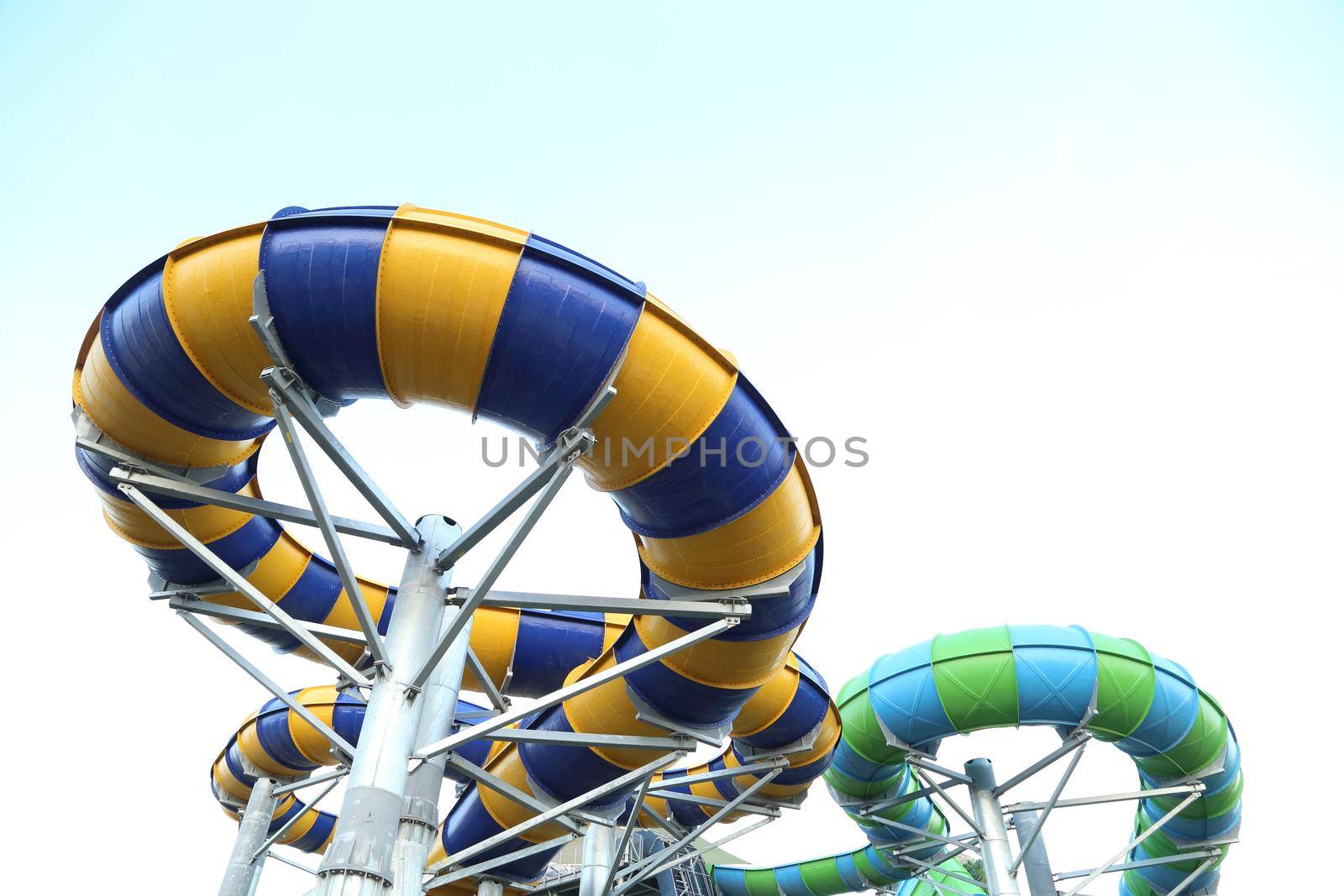 Slider in swimming pool with sky background