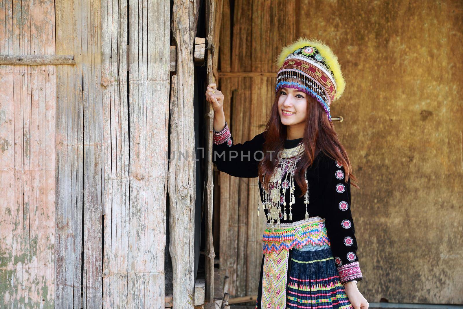 Traditionally dressed Mhong hill tribe woman in the wooden cottage