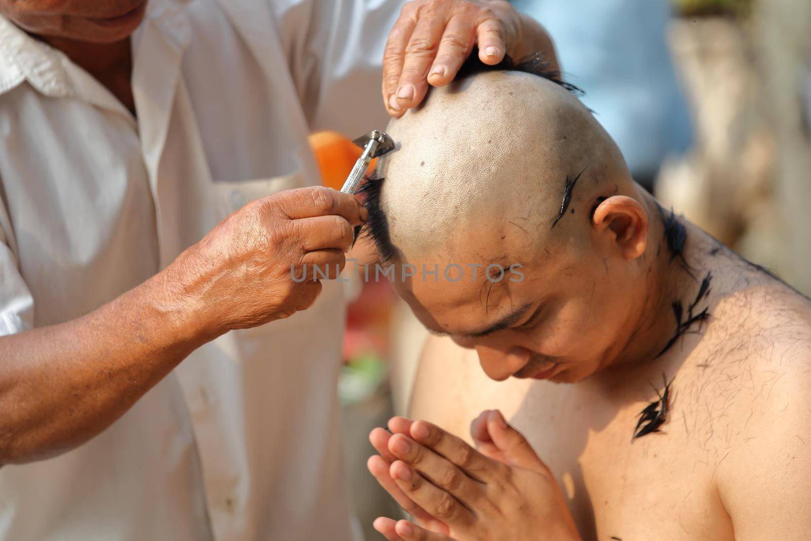 Male who will be monk shaving hair for be Ordained to new monk