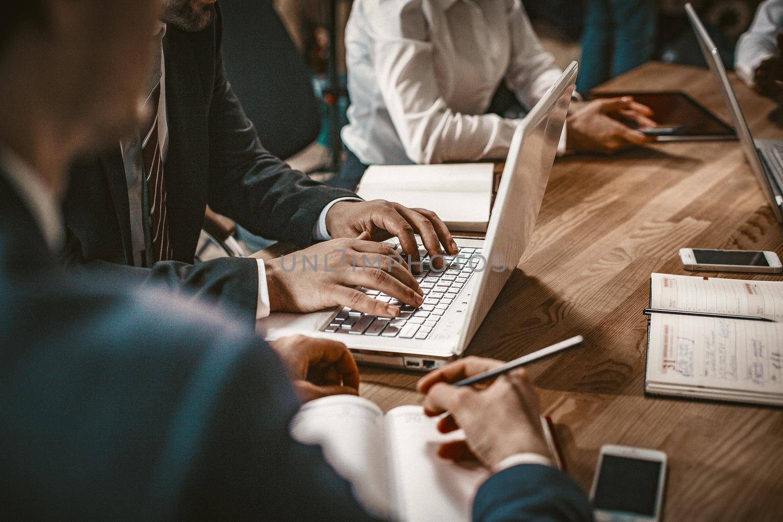 Teamwork of Business Partners during Business Metting At Board Room, White Collar Workers Brainstorming Together Using Laptop While Sitting At Table, Close Up Shot, Toned Image