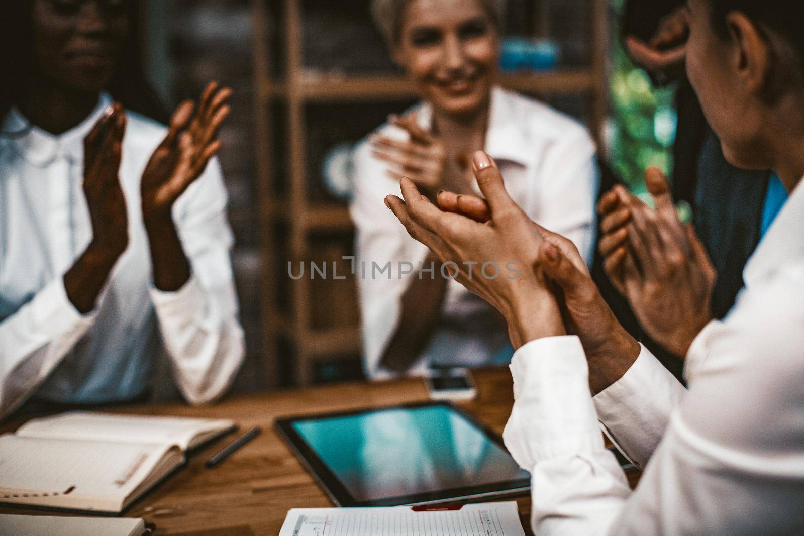 Applause After Successful Brainstorming, Сharming Multi-Ethnic Team Of Women Colleague In White Clothes Applauds At Business Meeting, Focus On Caucasian Woman Clapping Hands In Foreground, Toned Image