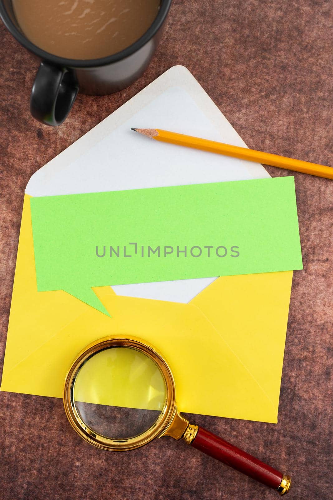 Blank Paper With Speech Bubble Shape, Envelope, Pencil, Coffee Mug And Magnifying Glass On Table. It Is Representing Important Marketing Strategies For Business Goals. by nialowwa