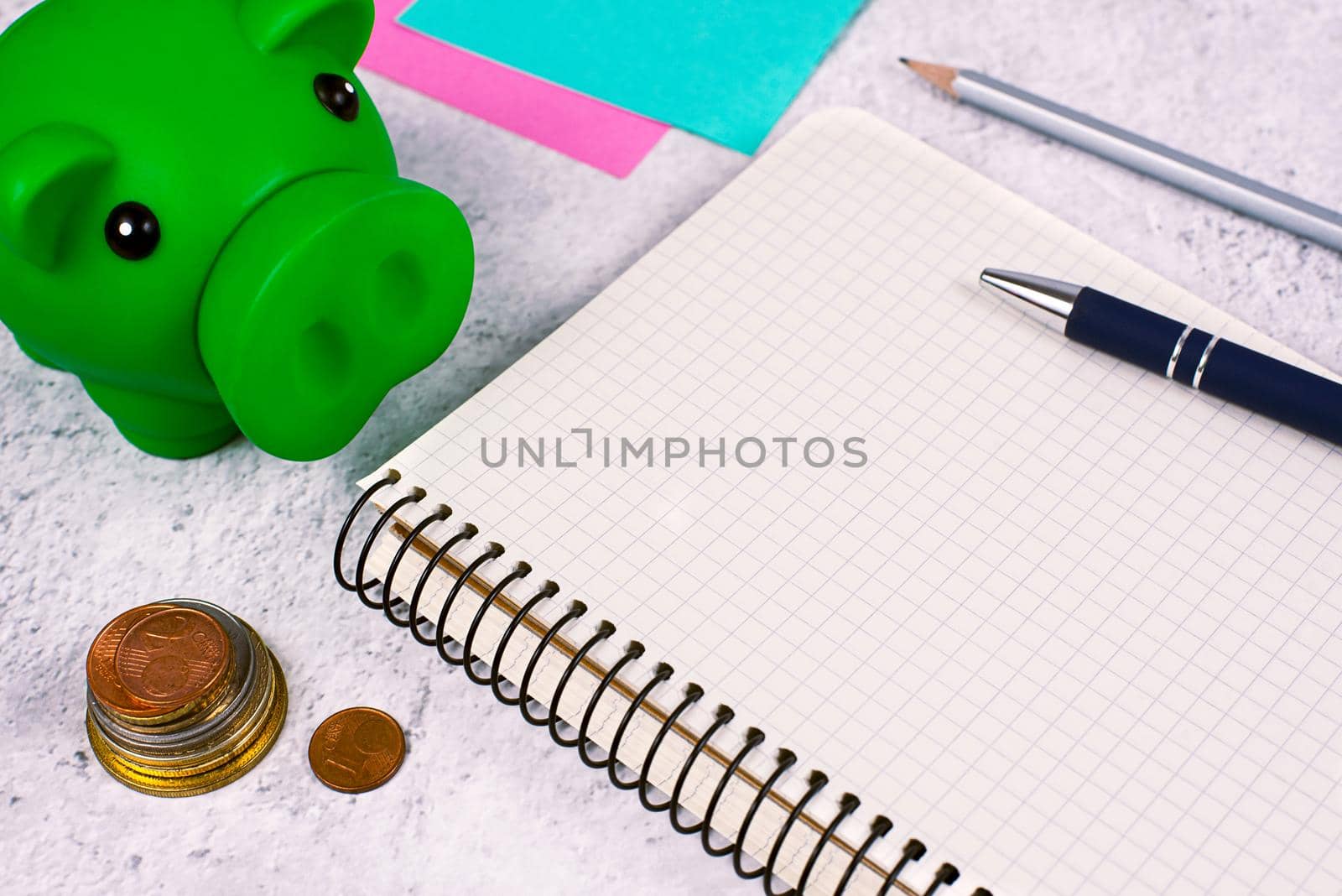 Important Message On Notebook On Desk With Money, Pen, Notes And Pig Box. Critical Informations On Notepad On Table With Cents, Memos And Pencil. New Ideas Presented. by nialowwa